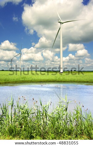 Picturesque landscape with wind generator  and lake on a background of the blue sky.  Picturesque landscape with wind generator  and lake on a background of the blue sky.