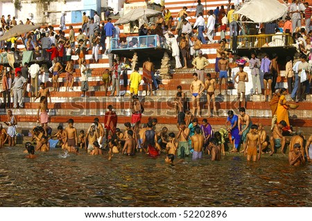 VARANASI, INDIA- FEBRUARY 26: Crowds of people worshiping bathing in the sacred River Ganges at Varanasi  February 26, 2006 in Varanasi, India.