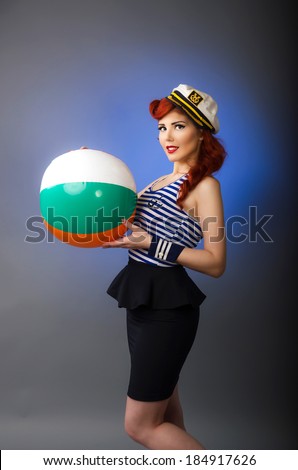 Vintage pin up girl wearing a sailor costume