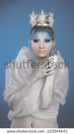 Studio portrait of a woman with creative make up and body painting as Ice Queen