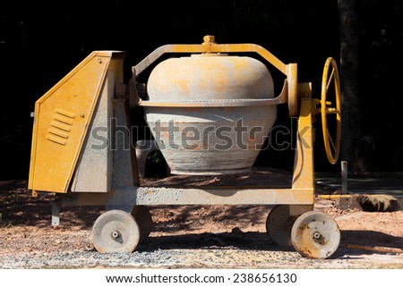 Industrial cement mixer machine at construction site.