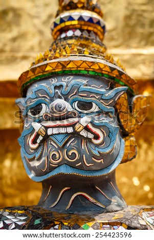 Close-up of demon guardian statue at the temple Wat phra kaew in the Grand palace, Bangkok, Thailand.