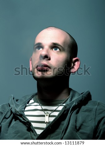 Low-key portrait about an attractive man with blue eyes who smokes