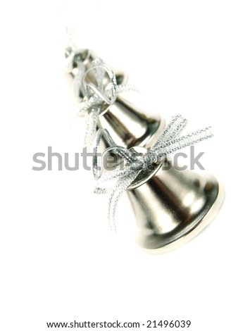 Closeup photo of a line of silver bells with nice ribbons as Christmas decoration. Isolated on white.