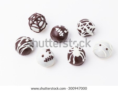 chocolate cakes in the form of monsters and skeletons for kids on Halloween on a white background horizontal.
