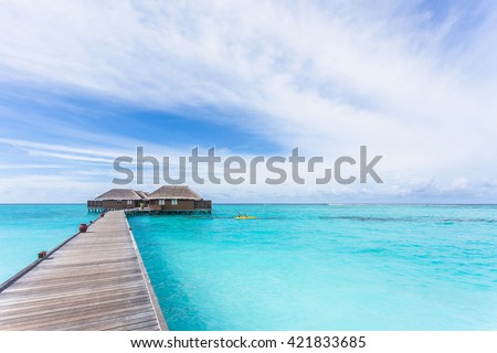 Water Villas (Bungalows) on the Perfect Tropical Island, Beautiful white sand on Tropical beach blue water and  blue sky, Maldives islands