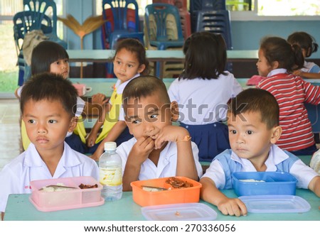 Srisaket  province,Thailand 26/01/2015 :Primary student in Thailand take lunch break at them school.  Ban Ku Mueng  School ,Srisaket  province, Thailand