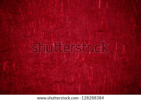 Grunge textured recycled red paper with natural fiber parts with vignetting