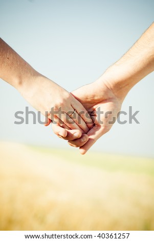 stock photo Closeup Holding Hands with Wedding Ring