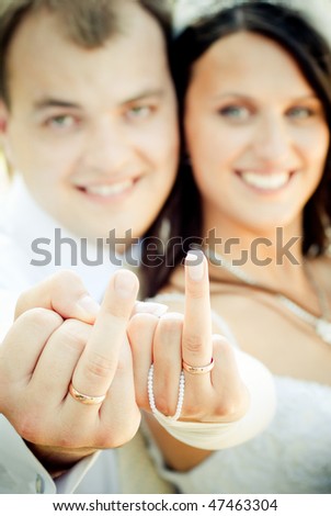 Happy Wedding Couple Showing Their Fingers With The Wedding Rings, Focus On The Rings