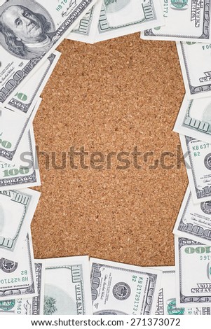 Empty corkboard with border made of 100 US dollars.
