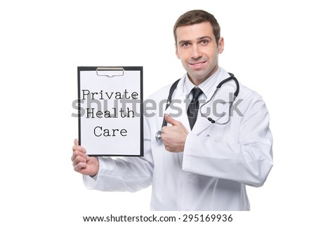 Smiling male doctor with clipboard with PRIVATE HEALTH CARE text and thumb up gesture. Isolated