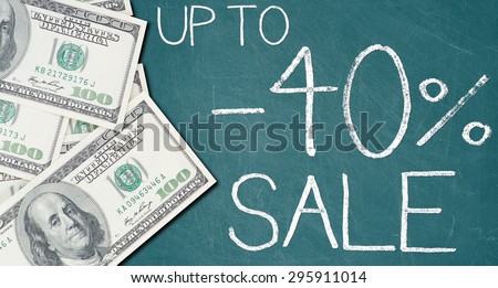 UP TO -40% SALE text written on a green chalkboard with frame made of 100 US dollars.