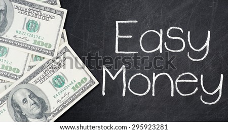 EASY MONEY text written on a blackboard with frame made of 100 US dollars.