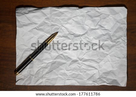 blank sheet of paper on the table with a pen