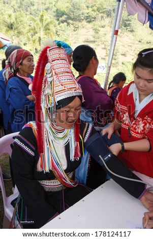 CHIANG MAI, THAILAND - JAN 27 : Unidentified  hill tribe was waitting for health service  with traditional clothes and silver jewelery at  Ban muang-ngam on january 27, 2014 in Chiang Mai, Thailand.