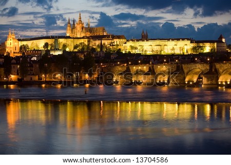 Panoramic night view to Lesser Town, Prague castle, St. Nicholas church and Charles bridge.