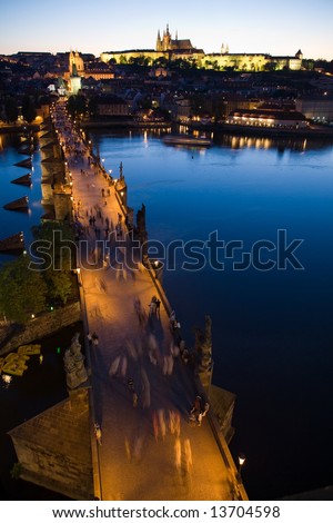 Panoramic night view to Lesser Town, Prague castle, St. Nicholas church and Charles bridge.