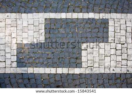 Prague sidewalk made from nature color stone cubes. Background texture.