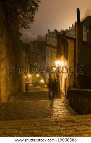 Old castle stairs from Prague castle to Little Quarter surrounded by Prague fog.