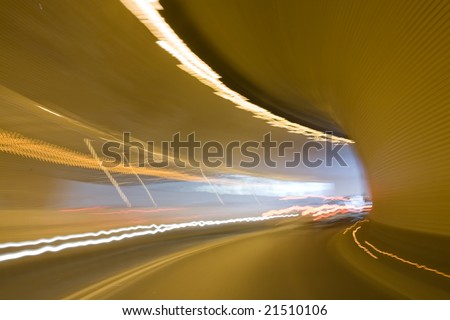 Right turn in tunnel with light tracks and light in the end of tunnel. Motion blur. Background texture.