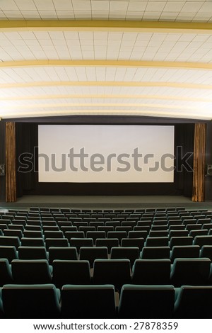Empty cinema auditorium with line of green chairs and silver screen. Ready for adding your own picture.