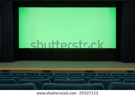 Empty cinema auditorium with line of blue chairs and green projection screen. Ready for adding your own picture.