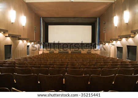 Empty cinema auditorium with row of chairs and projection screen. Ready for adding your own picture.