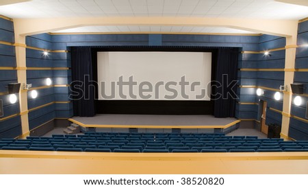Empty cinema auditorium with line of blue chairs and projection screen. Ready for adding your own picture.