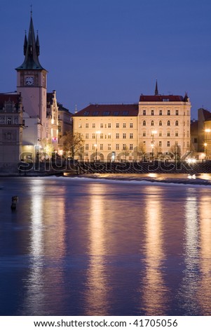Smetana embankment in Prague with city houses at night illumination. Winter view.