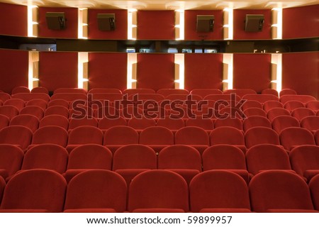 Interior of cinema auditorium with lines of chairs.