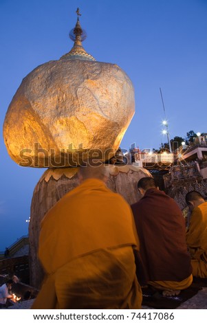 Golden Rock at night with praying people - one of the most Buddhist worship place in Burma.