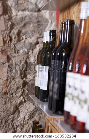 Wine bottles on a shelf in a wine shop