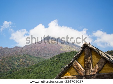 Mountain landscape and wooden cabin