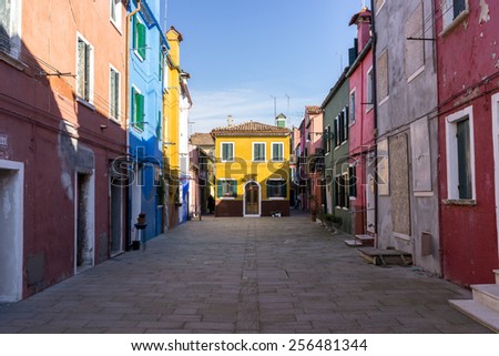 Burano, a small island off of Venice, quiet morning scenery. Colorful apartments and buildings lining up the street