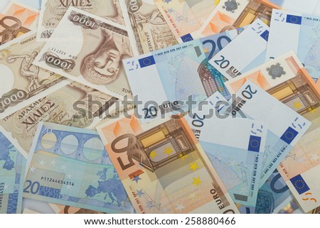 Old Greek 1000 drachmas banknotes and variety of euro bills.