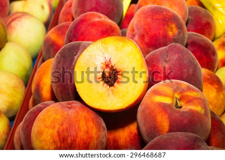 High energy food, health booster super fruit, juicy peaches on an open air fruit market bazaar.