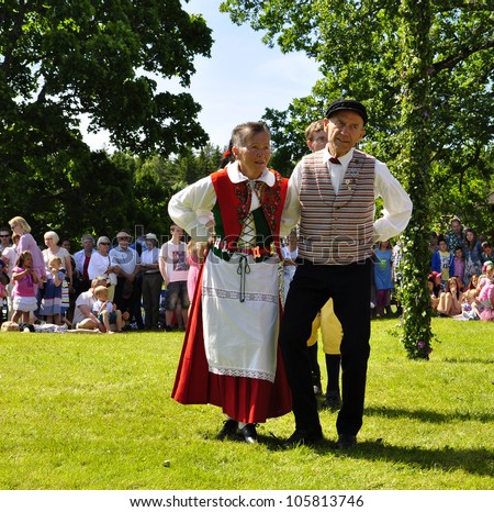 TORSTUNA, SWEDEN - JUNE 22: Unidentified people in folklore ensemble in traditional folk costume.The official name is midsummer event and org are hembygd Torstuna on June 22, 2012 in Torstuna Sweden