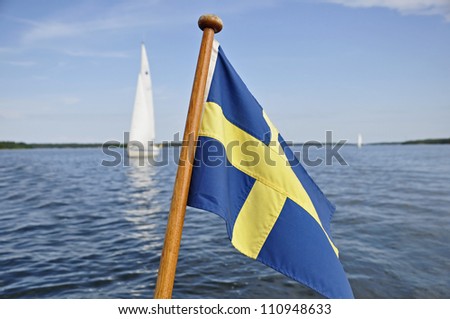 Detail of a sailboat along the coast, swedish flag