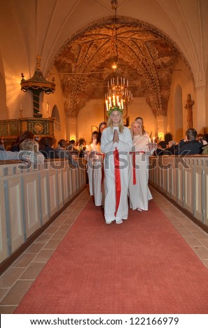 HEBY, SWEDEN - DECEMBER 16:unidentified people in Santa Lucia at christmas celebration in Heby church on December 16, 2012 in Heby Sweden