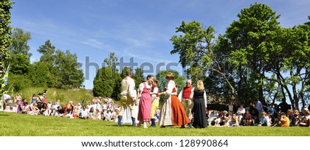 TORSTUNA, SWEDEN -  JUNE 22: Unidentified people in folklore ensemble in midsummer event. The official name is midsummer event and organization are hembygd Torstuna on June 22, 2012 in Torstuna Sweden