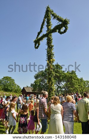 TORSTUNA,SWEDEN - JUNE 21: Unidentified people dancing around maypole in midsummer event. The official name is midsummer event and organization are hembygd Torstuna on June 21, 2013 in Torstuna Sweden