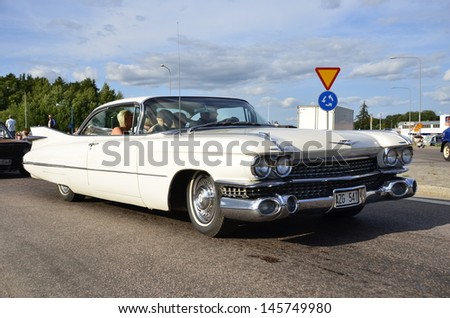 VASTERAS, SWEDEN - JULY 6: Unidentified people in power big meet cruising with old classic car. official name is power meet and organization are power big meet on July 6, 2013 in Vasteras Sweden