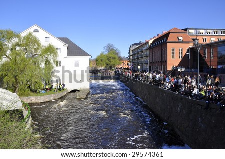 UPPSALA, SWEDEN - 30 APRIL : People wait for a boat race in Uppsala, April 30 2009 in Uppsala, Sweden. Lot of people come together and have fun in the last day of April every year.