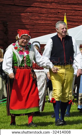 TORSTUNA,SWEDEN-JUNE 19: Folklore couple of Sweden in traditional costume at midsummer day June 19 2009 in Torstuna, Sweden