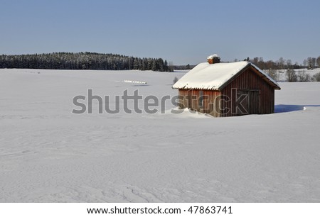 Old barn in a wintry landscape