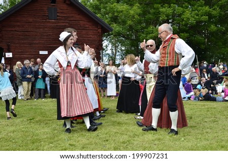 TORSTUNA, SWEDEN - JUNE 20: Unidentified people in folklore ensemble in midsummer event. The official name is midsummer event and organization are hembygd Torstuna on June 20, 2014 in Torstuna Sweden