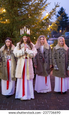 HEBY, SWEDEN - DECEMBER 13: Undentified people in Santa Lucia at Christmas celebration in Heby city on December 13, 2014 in Heby Sweden