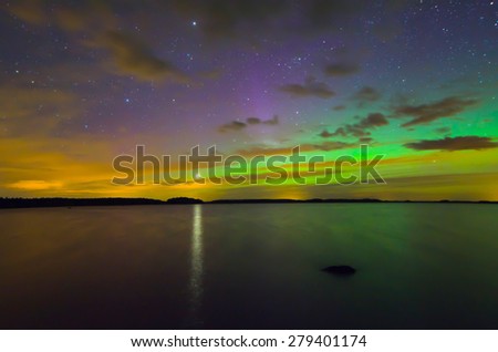 Scenic view of northern lights over frozen lake in Sweden and the star of venus (Aurora borealis)