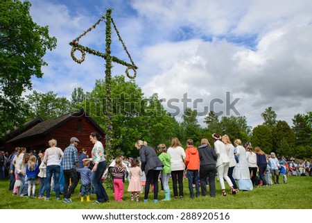 TORSTUNA, SWEDEN- JUNE 19: Unidentified people dancing around maypole in midsummer event. The official name is midsummer event and organization are,hembygd Torstuna on June 19 2015 in Torstuna Sweden